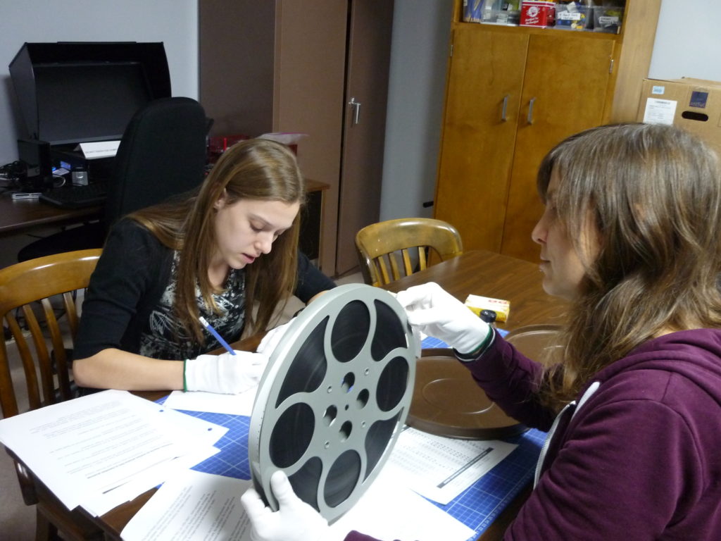 Students making film condition report